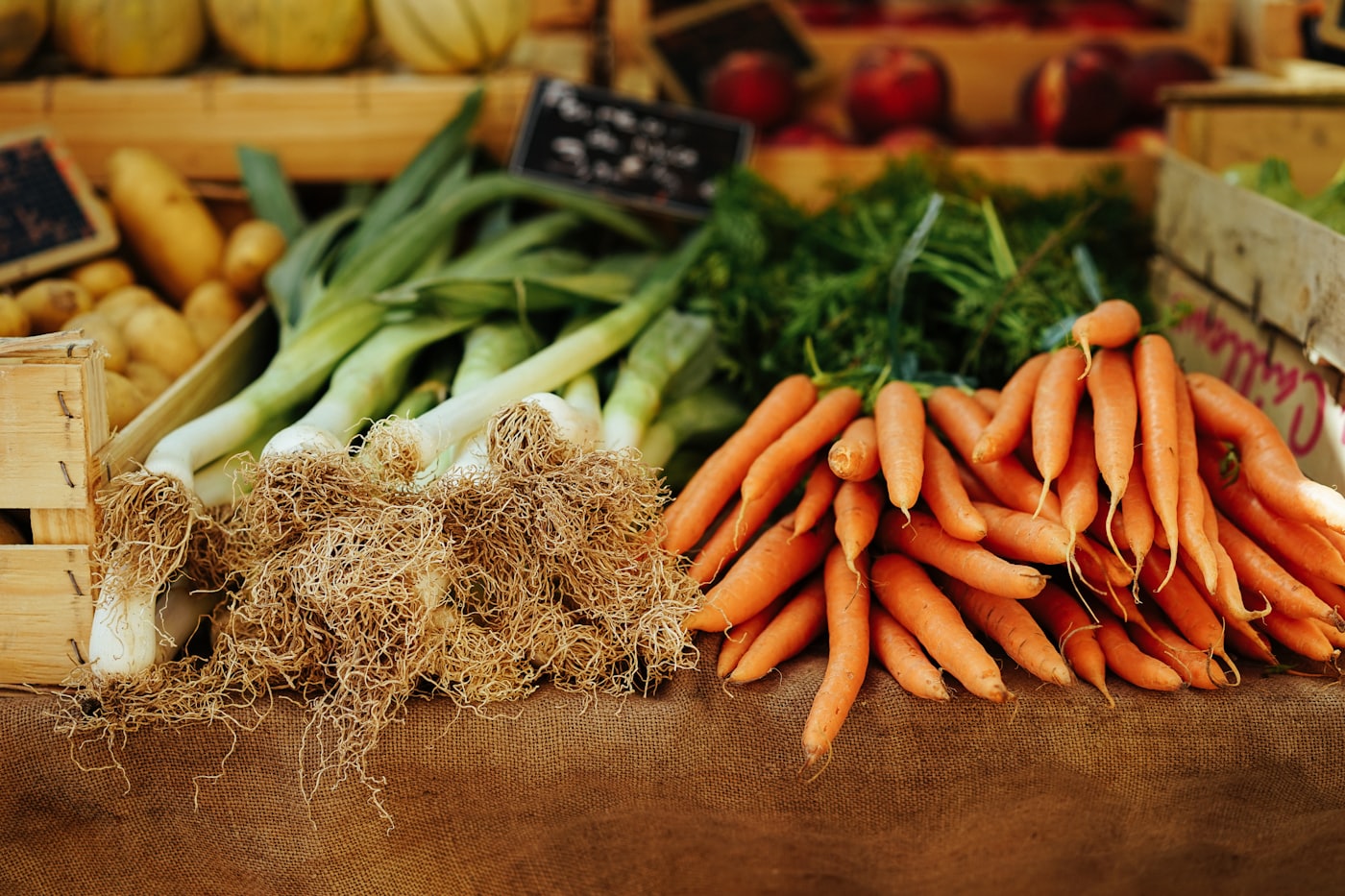 Crates of carrots and leeks at a market stall
